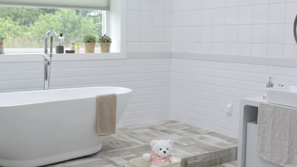 A Full Bathroom with Tile Floors and White Tile Walls